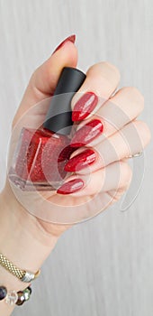 Female hands with long nails with red nail polish