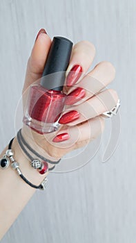 Female hands with long nails with red nail polish