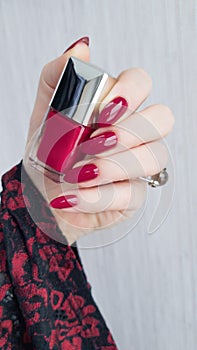 Female hands with long nails with red nail polish