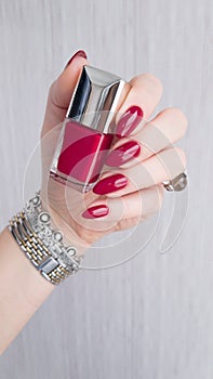 Female hands with long nails with red nail polish