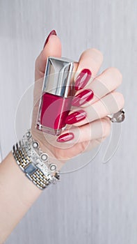 Female hands with long nails with red nail polish