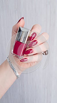 Female hands with long nails with red nail polish