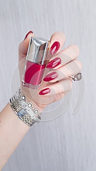 Female hands with long nails with red nail polish