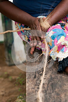 Female hands make a corn from coconut copra fibre