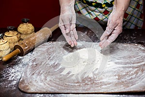 Female hands making dough for pizza. Making bread