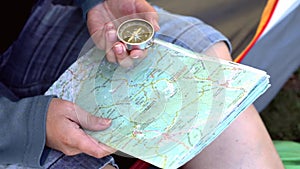 Female hands with map and compass