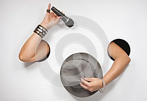 Female hands with microphone and hat