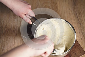 Female hands mixing sticky dough