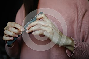 Female hands with nailfile. Manicure concept photo