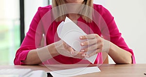 Female hands open envelope and read letter