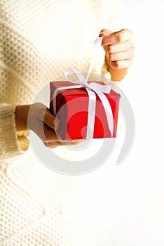 Female hands opening red gift box, copy space. Christmas, new year, birthday party, valentine`s day, mother`s and woman