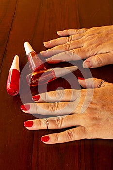 Female hands painting their own nails.