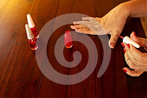 Female hands painting their own nails.