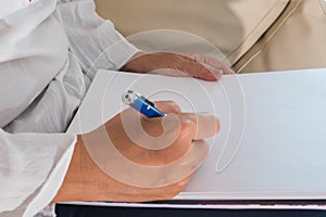 Female hands with pen writing in the notebook