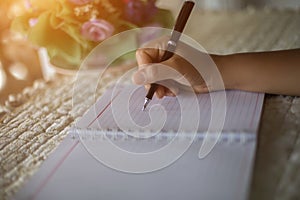 Female hands with pen writing on notebook coffee cafe