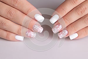 Female hands with pink and white manicure nails