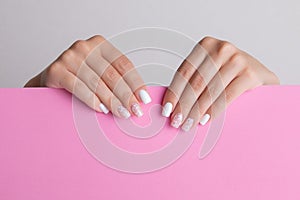 Female hands with pink and white manicure nails