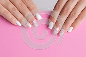 Female hands with pink and white manicure nails