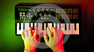 Female hands play on a midi keyboard record music