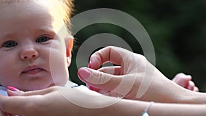 Female hands playing with baby face