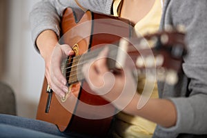 female hands playing guitar