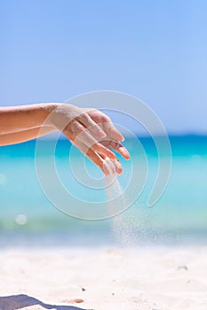 Female hands playing in the sand