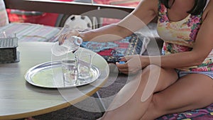 Female hands pouring clean water into a glass