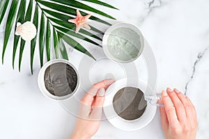 Female hands preparing face clay mask, top view. SPA natural organic cosmetics, face treatment, skin care concept