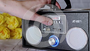 Female Hands Pressing Buttons, Rotates Handle on a Portable Audio Tape Recorder