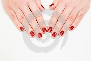 Female hands with professional red manicure