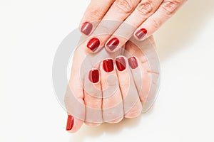 Female hands with professional red manicure