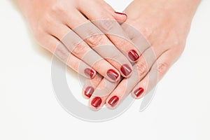 Female hands with professional red manicure