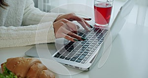 Female hands professional user worker using typing on laptop notebook keyboard sit at home office desk working online