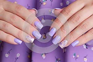 Female hands with purple manicure nails
