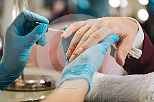 Female hands putting nail polish