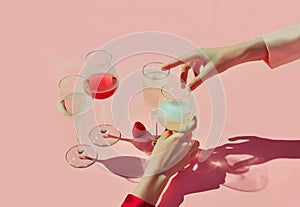 Female hands reaching for the champagne glasses with strawberries bellow.