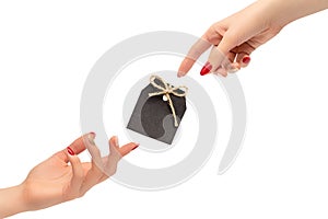 Female hands with red and golden nail polish. Creation of man concept with black tag isolated on white background