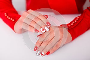 Female hands with red manicure nails, hearts design