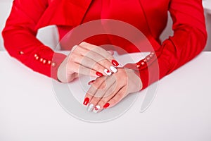 Female hands with red manicure nails, hearts design