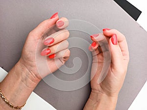 Female hands with red nail design. Manicure and Hands Spa. . Beauty treatment. Beautiful woman`s nails with beautiful baby boomer