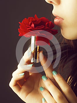 Female hands with red rose lipstick