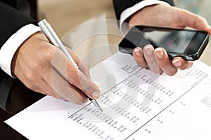 Female hands reviewing accounting document.