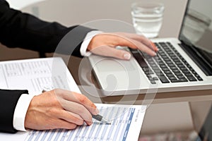 Female hands reviewing documents.