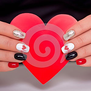 Female hands with romantic manicure nails, hearts design