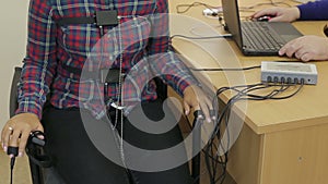 Female hands on the sensors lie detector test close up