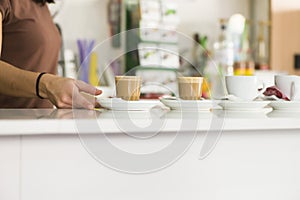 A female hands serving coffees in a coffee shop photo