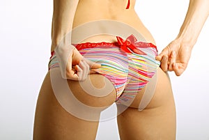 Female hands settle swimming trunks