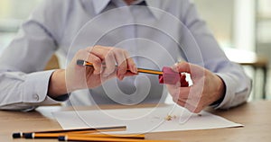 Female hands sharpen pencil in red sharpener in office