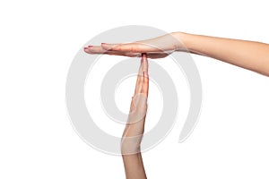 Female hands show a timeout or pause sign on white background.