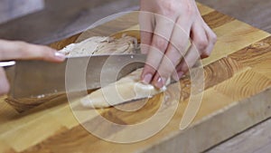 Female hands sliced chicken breast close-up